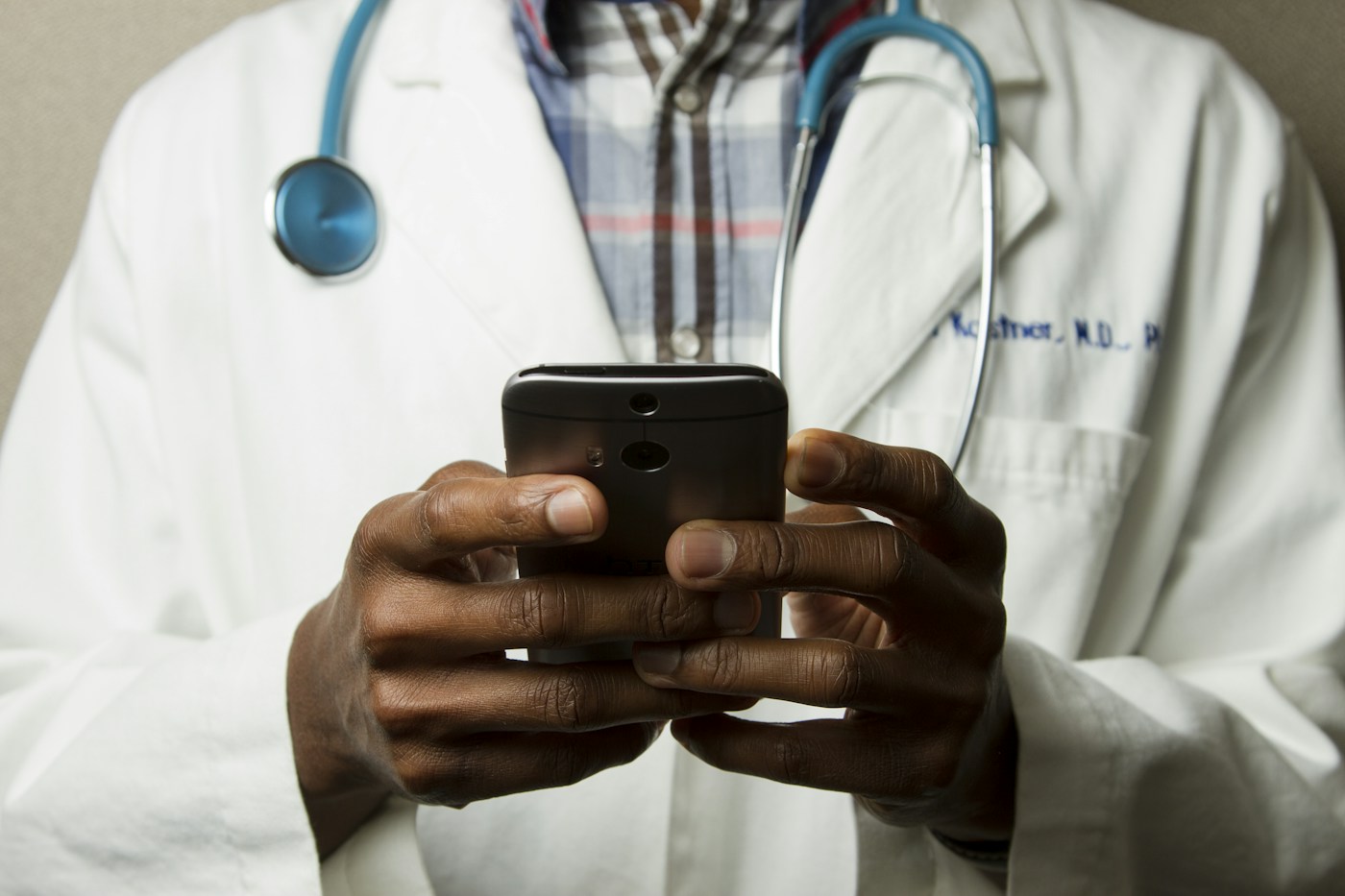 A healthcare professional using a smartphone